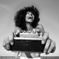 Buy canvas prints of Laughing Afro American girl taking selfie on beach by Spotmatik 