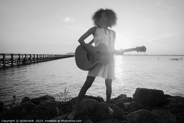 Afro American girl playing guitar with ocean sunset Picture Board by Spotmatik 