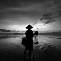 Buy canvas prints of Balinese male fishing at sunrise Flores sea coastline  by Spotmatik 