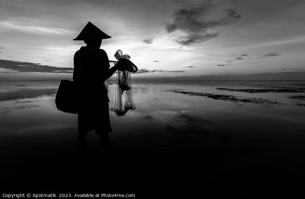 Silhouette Balinese male fishing Indonesian coastline at sunrise Picture Board by Spotmatik 