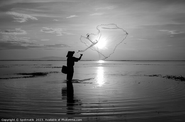 Sunrise Silhouette local Balinese fisherman casting his net  Picture Board by Spotmatik 