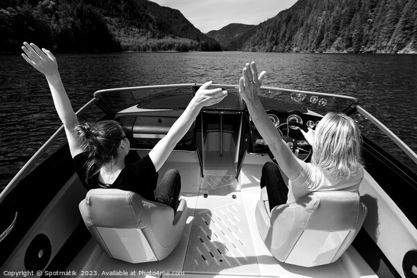 Female partners speeding across Vancouver mountain lake Picture Board by Spotmatik 