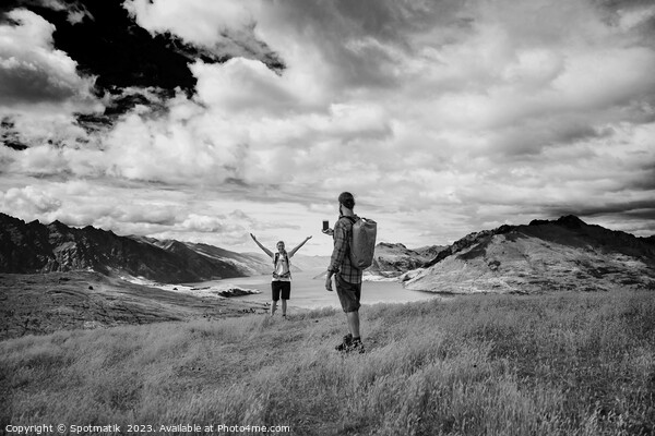 Successful young couple taking smartphone picture Lake Wakatipu  Picture Board by Spotmatik 
