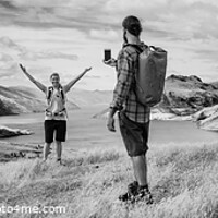 Buy canvas prints of Panorama of young backpacking couple taking smartphone picture by Spotmatik 