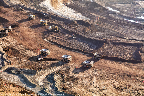 Aerial view giant dump trucks carrying mined Oilsand  Picture Board by Spotmatik 