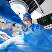 Buy canvas prints of Caucasian surgical team wearing scrub operating on patient by Spotmatik 