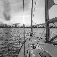 Buy canvas prints of Sailing luxury yacht at sunset with cityscape view by Spotmatik 