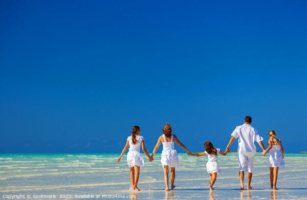 Happy Caucasian family on tropical beach enjoying leisure Picture Board by Spotmatik 