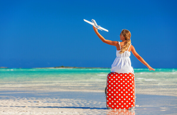 Girl sitting on red travel luggage on beach plane Picture Board by Spotmatik 