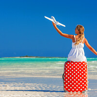 Buy canvas prints of Girl sitting on red travel luggage on beach plane by Spotmatik 