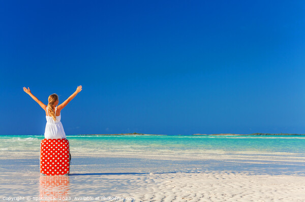 Blonde girl having beach fun sitting on suitcase Picture Board by Spotmatik 