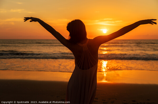Carefree Bohemian girl dancing on beach at sunset Picture Board by Spotmatik 
