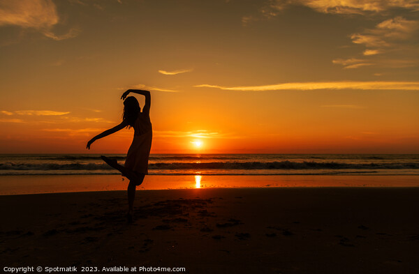 Happy young girl dancing on beach at sunset Picture Board by Spotmatik 