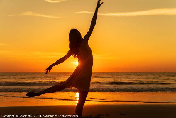 Sunset view carefree young girl dancing on beach Picture Board by Spotmatik 