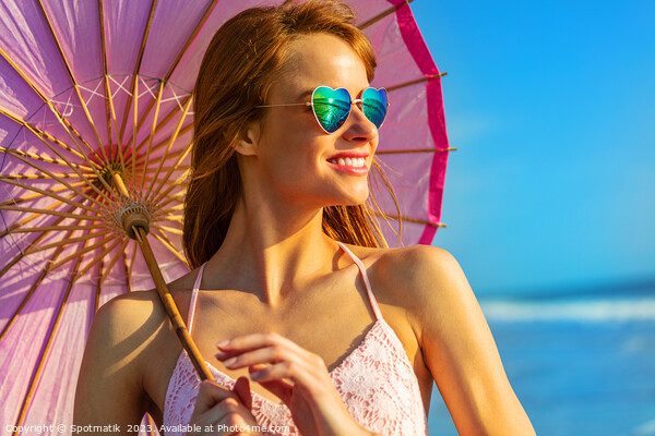 Smiling American hippy chic with parasol on beach Picture Board by Spotmatik 