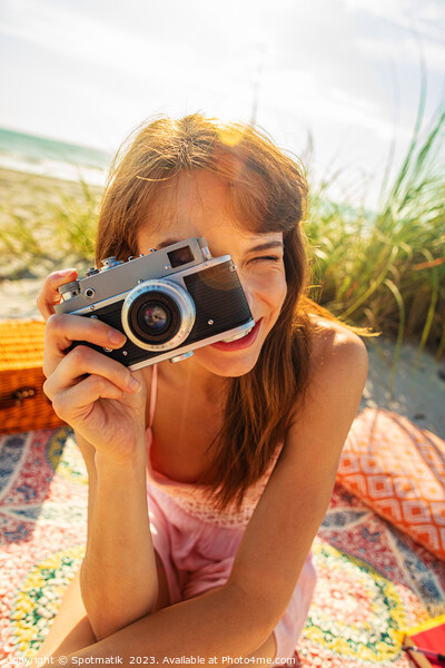 Smiling Caucasian girl with camera photographing beach vacation Picture Board by Spotmatik 
