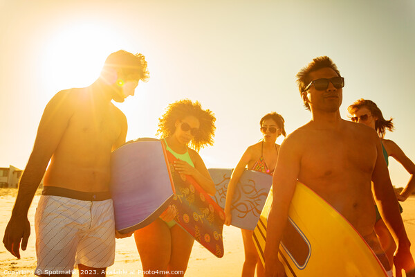 Group of friends with bodyboards on beach vacation Picture Board by Spotmatik 