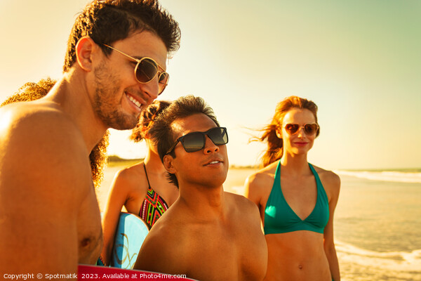 Friends on beach going bodyboarding on Summer vacation Picture Board by Spotmatik 