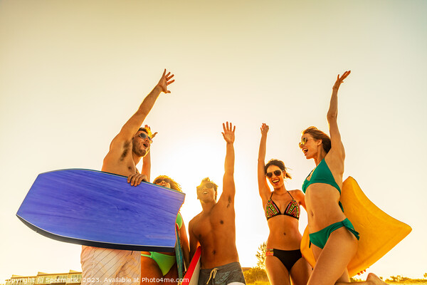 Friends in swimwear with bodyboards celebrating Summer vacation Picture Board by Spotmatik 