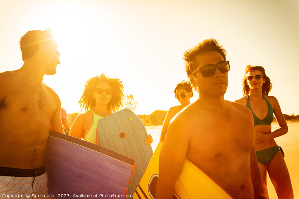 Friends in swimwear carrying bodyboards enjoying Summer vacation Picture Board by Spotmatik 