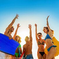 Buy canvas prints of Friends in swimwear carrying bodyboards celebrating fun activity by Spotmatik 