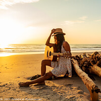 Buy canvas prints of Indian female sitting on driftwood with ocean sunrise by Spotmatik 