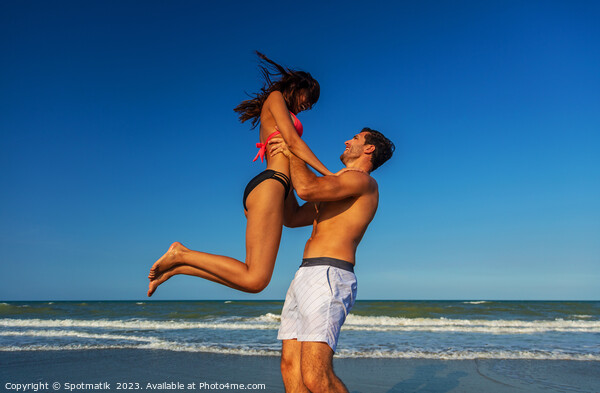 Male and female in swimwear enjoying Summer fun Picture Board by Spotmatik 