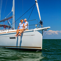 Buy canvas prints of Loving retired couple relaxing together on luxury yacht by Spotmatik 