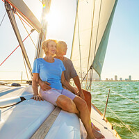 Buy canvas prints of Senior couple enjoying togetherness on yacht at sunset by Spotmatik 