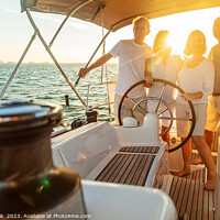 Buy canvas prints of Senior friends enjoying retirement steering yacht at sunset by Spotmatik 