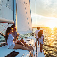 Buy canvas prints of Hispanic family enjoying vacation on yacht at sunset by Spotmatik 