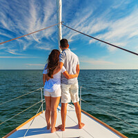 Buy canvas prints of Loving young Latino couple standing on luxury yacht by Spotmatik 