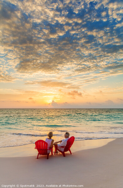 Retired Caucasian couple on beach at sunset Bahamas Picture Board by Spotmatik 