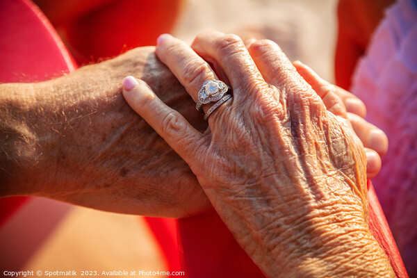 Linked hands of senior Caucasian couple on vacation Picture Board by Spotmatik 