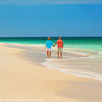 Buy canvas prints of Mature couple paddling on tropical island shoreline Bahamas by Spotmatik 