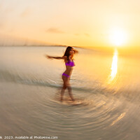Buy canvas prints of Motion blurred sunset ocean view with dancing female by Spotmatik 