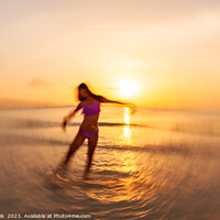 Buy canvas prints of Motion blurred Asian girl dancing in ocean sunset by Spotmatik 