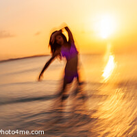 Buy canvas prints of Panoramic ocean sunset with dancing female motion blur by Spotmatik 