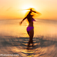 Buy canvas prints of Panoramic ocean sunset with dancing girl motion blur by Spotmatik 