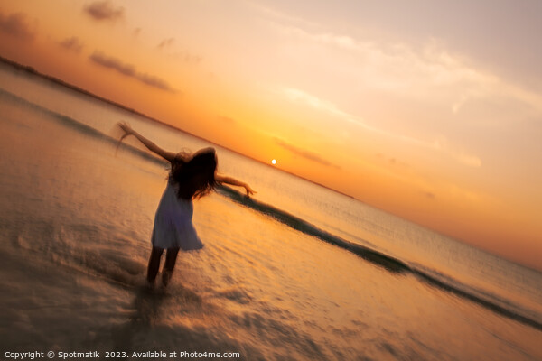 Motion blur girl standing in ocean at sunrise Picture Board by Spotmatik 