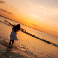 Buy canvas prints of Motion blur girl standing in ocean at sunrise by Spotmatik 