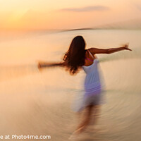 Buy canvas prints of Motion blurred panoramic ocean sunset with dancing girl by Spotmatik 