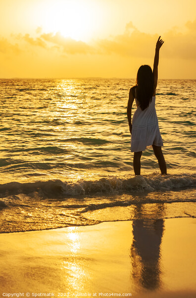 Young Asian woman enjoying ocean sunset on vacation Picture Board by Spotmatik 