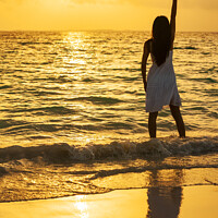 Buy canvas prints of Young Asian woman enjoying ocean sunset on vacation by Spotmatik 