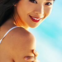 Buy canvas prints of Portrait of smiling Asian girl on relaxing vacation by Spotmatik 