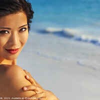 Buy canvas prints of Portrait of smiling Asian woman by ocean waves by Spotmatik 