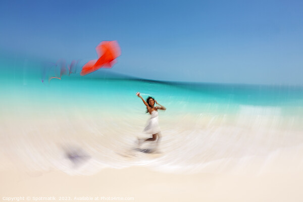Motion blurred young woman flying kite on beach Picture Board by Spotmatik 