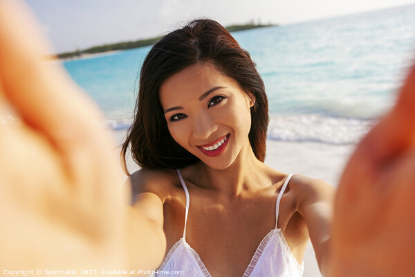Portrait of beautiful Asian girl smiling by ocean Picture Board by Spotmatik 