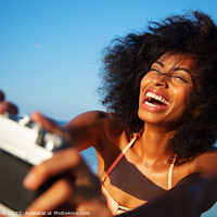 Buy canvas prints of Afro girl laughing at camera taking fun selfie by Spotmatik 