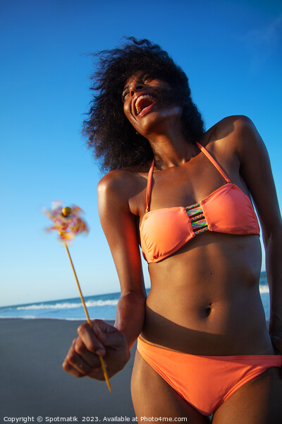 Young African American female having fun on beach Picture Board by Spotmatik 
